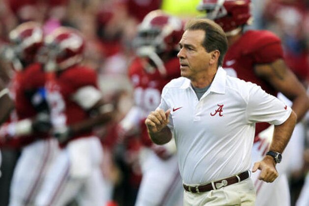FILE - In this Oct. 19, 2013, file photo, Alabama head coach Nick Saban runs onto the field before the first half of an NCAA college football game against Arkansas in Tuscaloosa, Ala. Saban is one national title away from matching Bear Bryant's record and, with his 65th birthday coming up on Halloween, shows no signs of slowing down.  (AP Photo/Butch Dill, File)