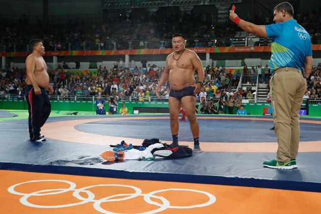 Mongolia's Mandakhnaran Ganzorig's coaches react after the judges announced that Uzbekistan's Ikhtiyor Navruzov won folling a video replay in their men's 65kg freestyle bronze medal match on August 21, 2016, during the wrestling event of the Rio 2016 Olympic Games at the Carioca Arena 2 in Rio de Janeiro. / AFP / Jack GUEZ        (Photo credit should read JACK GUEZ/AFP/Getty Images)