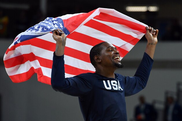 USA's guard Kevin Durant celebrates with USA's flag after defeating Serbia during a Men's Gold medal basketball match between Serbia and USA at the Carioca Arena 1 in Rio de Janeiro on August 21, 2016 during the Rio 2016 Olympic Games. / AFP / Andrej ISAKOVIC        (Photo credit should read ANDREJ ISAKOVIC/AFP/Getty Images)