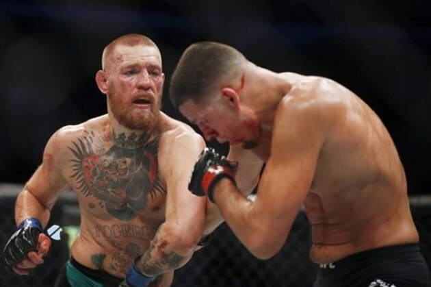 Conor McGregor fights Nate Diaz during their welterweight mixed martial arts bout at UFC 202 on Saturday, Aug. 20, 2016, in Las Vegas. McGregor won by split decision. (AP Photo/Isaac Brekken)