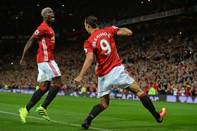 Manchester United's Swedish striker Zlatan Ibrahimovic (R) celebrates with Manchester United's French midfielder Paul Pogba after scoring their second goal from the penalty spot during the English Premier League football match between Manchester United and Southampton at Old Trafford in Manchester, north west England, on August 19, 2016. / AFP / Oli SCARFF / RESTRICTED TO EDITORIAL USE. No use with unauthorized audio, video, data, fixture lists, club/league logos or 'live' services. Online in-match use limited to 75 images, no video emulation. No use in betting, games or single club/league/player publications.  /         (Photo credit should read OLI SCARFF/AFP/Getty Images)