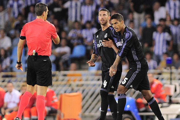 Real Madrid's defender Sergio Ramos (L) and French defender Raphael Varane (R) protest during the Spanish league football match Real Sociedad vs Real Madrid CF at the Anoeta stadium in San Sebastian on August 21, 2016. / AFP / ANDER GILLENEA        (Photo credit should read ANDER GILLENEA/AFP/Getty Images)