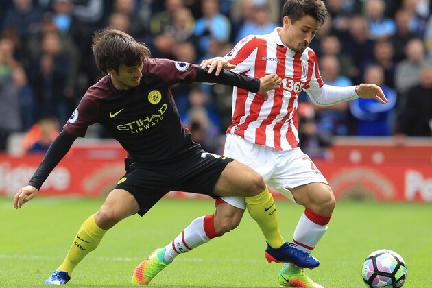Stoke City's Spanish striker Bojan Krkic vies with Manchester City's Spanish midfielder David Silva (L) during the English Premier League football match between Stoke City and Manchester City at the Bet365 Stadium in Stoke-on-Trent, central England on August 20, 2016. / AFP / Lindsey PARNABY / RESTRICTED TO EDITORIAL USE. No use with unauthorized audio, video, data, fixture lists, club/league logos or 'live' services. Online in-match use limited to 75 images, no video emulation. No use in betting, games or single club/league/player publications.  /         (Photo credit should read LINDSEY PARNABY/AFP/Getty Images)