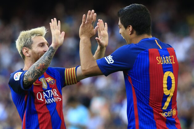 Barcelona's Uruguayan forward Luis Suarez (R) celebrates after scoring with Barcelona's Argentinian forward Lionel Messi during the Spanish league football match FC Barcelona vs Real Betis Balompie at the Camp Nou stadium in Barcelona on August 20, 2016. / AFP / PAU BARRENA        (Photo credit should read PAU BARRENA/AFP/Getty Images)