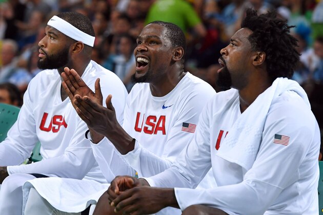 USA's guard Kevin Durant(C) reacts from the bench, sitting between USA's centre DeMarcus Cousins (L) and USA's centre DeAndre Jordan during a Men's quarterfinal basketball match between USA and Argentina at the Carioca Arena 1 in Rio de Janeiro on August 17, 2016 during the Rio 2016 Olympic Games. / AFP / Andrej ISAKOVIC        (Photo credit should read ANDREJ ISAKOVIC/AFP/Getty Images)