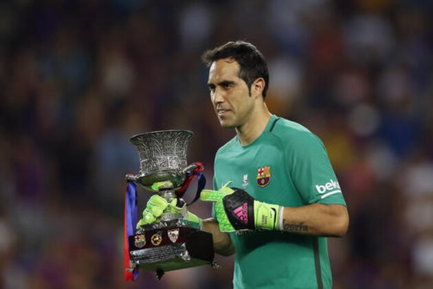 FC Barcelona's goalkeeper Claudio Bravo celebrates with the trophy after winning the Spanish Super Cup between FC Barcelona and Sevilla at the Camp Nou in Barcelona, Spain, Thursday, Aug. 18, 2016. (AP Photo/Manu Fernandez)