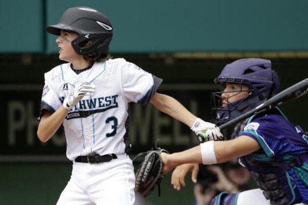 Bend, Oregon's Julian Mora (3) drives in a run with a single against Italy during the fourth inning of a consolation baseball game at the Little League World Series tournament in South Williamsport, Pa., Monday, Aug. 22, 2016. Catching is Italy's Samuele Gamberini. (AP Photo/Gene J. Puskar)