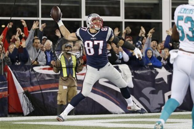 ADVANCE FOR SUNDAY, NOV. 8 AND THERAFTER - In this photo taken Oct. 29, 2015, New England Patriots tight end Rob Gronkowski (87) celebrates his touchdown in the first half an NFL football game against the Miami Dolphins in Foxborough, Mass. If New England can beat visiting Washington on Sunday, which it is heavily favored to do, the Patriots would improve to 8-0, halfway to a second perfect regular season. (AP Photo/Michael Dwyer)