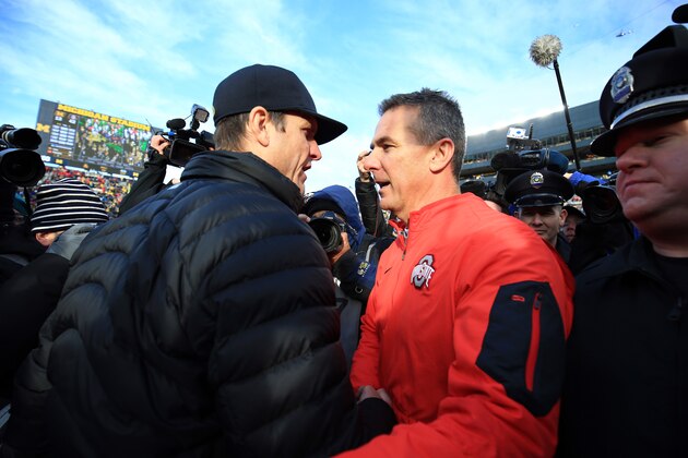 ANN ARBOR, MI - NOVEMBER 28: Head coach Urban Meyer of the Ohio State Buckeyes and head coach Jim Harbaugh of the Michigan Wolverines after the game against the Michigan Wolverines at Michigan Stadium on November 28, 2015 in Ann Arbor, Michigan. Ohio State defeated Michigan 42-13. (Photo by Andrew Weber/Getty Images)