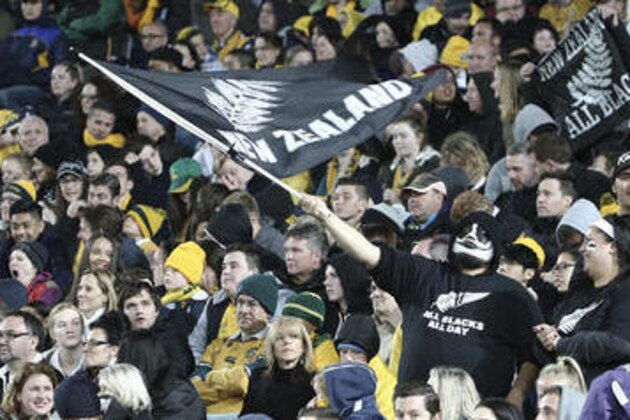 A New Zealand rugby fan waves a flag after the All Blacks scored a try during their Bledisloe Cup Rugby test match against Australia in Sydney, Australia, Saturday, Aug. 20, 2016.(AP Photo/Rob Griffith)