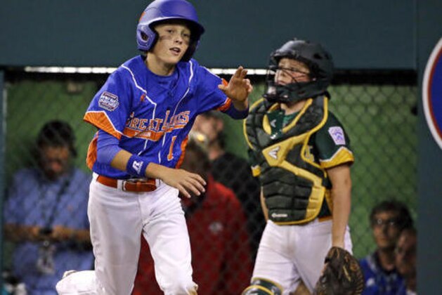 Bowling Green, Ky.'s Tate Hanks, left, runs past Johnston, Iowa catcher Owen Dawson on the way to his dugout after scoring on a wild pitch during the seventh inning of a baseball game in United States pool play at the Little League World Series tournament in South Williamsport, Pa., Monday, Aug. 22, 2016. (AP Photo/Gene J. Puskar)