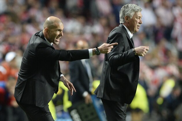 Real Madrid's assistant manager Zinedine Zidane (L) and Real Madrid's Italian coach Carlo Ancelotti react during the UEFA Champions League Final Real Madrid vs Atletico de Madrid at Luz stadium in Lisbon, on May 24, 2014.   AFP PHOTO/ FRANCK FIFE        (Photo credit should read FRANCK FIFE/AFP/Getty Images)