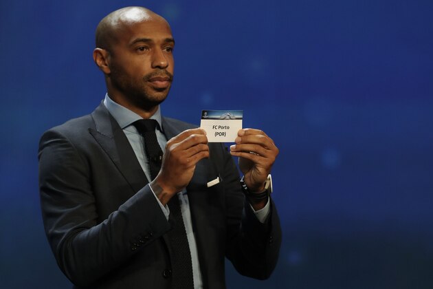 French former football player Thierry Henry shows a piece of paper bearing the name of FC Porto during the UEFA Champions League Group stage draw ceremony, on August 25, 2016 in Monaco. / AFP / Valery HACHE        (Photo credit should read VALERY HACHE/AFP/Getty Images)