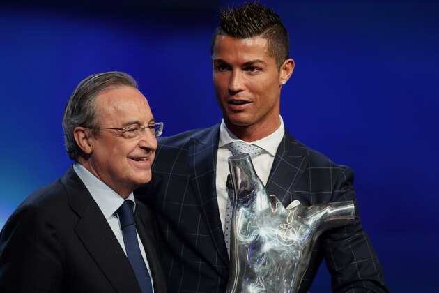 Real Madrid's Portuguese forward Cristiano Ronaldo (R) holds his trophy of Best Men's player in Europe next to Real Madrid President Florentino Perez at the end of the UEFA Champions League Group stage draw ceremony, on August 25, 2016 in Monaco. / AFP / VALERY HACHE        (Photo credit should read VALERY HACHE/AFP/Getty Images)