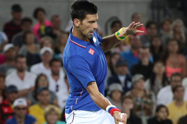 Aug 7, 2016; Rio de Janeiro, Brazil; Novak Djokovic (SRB) hits a forehand against Juan Martin Del Potro (ARG, not pictured) during the men's singles in the Rio 2016 Summer Olympic Games at Olympic Tennis Centre. Mandatory Credit: Jeff Swinger-USA TODAY Sports
