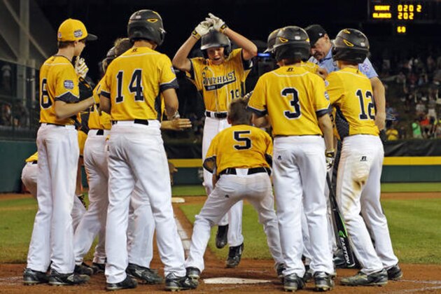Goodlettsville, Tenn.'s Zach McWilliams, center, is greeted by teammates after hitting a grand slam off Bowling Green, Ky.'s Drew Wolfram during the fourth inning of a baseball game at the Little League World Series in South Williamsport, Pa., Thursday, Aug. 25, 2016. (AP Photo/Gene J. Puskar)
