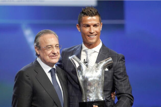 Real Madrid's forward Cristiano Ronaldo of Portugal, right, holds his best player of the year trophy, as he poses with Real Madrid's President Florentino Perez, during the UEFA Champions League draw, at the Grimaldi Forum, in Monaco, Thursday, Aug. 25, 2016. (AP Photo/Claude Paris)