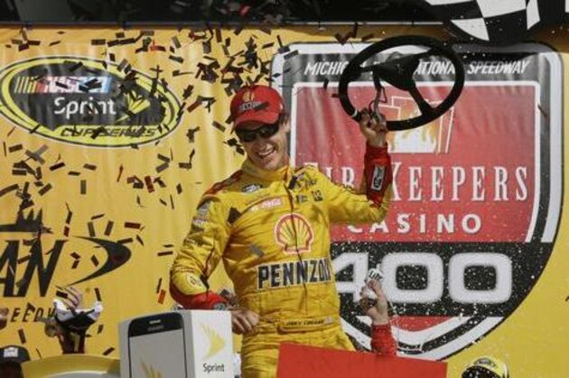 Joey Logano celebrates after winning the NASCAR Sprint Cup series auto race at Michigan International Speedway, Sunday, June 12, 2016 in Brooklyn, Mich. (AP Photo/Carlos Osorio)