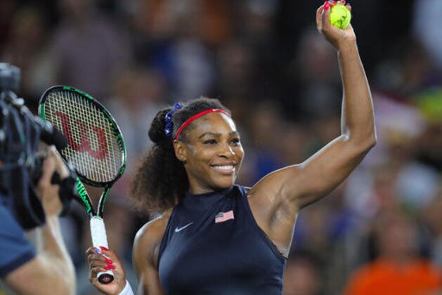 Serena Williams of the United States prepares to shoot an autographed ball into the tribune after defeating France's Alize Cornet in the women's tennis competition at the 2016 Summer Olympics in Rio de Janeiro, Brazil, Monday, Aug. 8, 2016. (AP Photo/Vadim Ghirda)