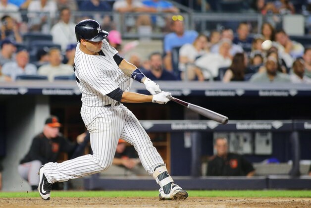 Aug 26, 2016; Bronx, NY, USA; New York Yankees catcher Gary Sanchez (24) hits a two run home run against the Baltimore Orioles during the fifth inning at Yankee Stadium. Mandatory Credit: Andy Marlin-USA TODAY Sports