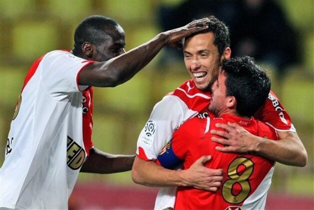 Monaco's Nene of Brazil, center, reacts with Monaco's Djimi Traore of Mali, left, and Monaco's Alejandro Alonso of Argentina after scoring the third goal during their French League One soccer match, Saturday, Jan. 30, 2010 in Monaco stadium. (AP Photo/Lionel Cironneau)