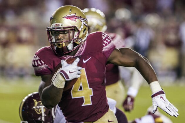 FILE - In this Sept. 5, 2015, file photo, Florida State running back Dalvin Cook runs the ball during the first half of an NCAA college football game against Texas State in Tallahassee, Fla. Florida State offense which returns all 11 starters , is led by Heisman Trophy contender Dalvin Cook. The junior rushed for a school-record 1,691 yards last season and tied for the national lead with six carries of 50 yards or more. (AP Photo/Mark Wallheiser, File)
