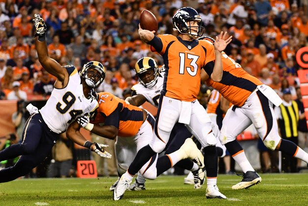 Aug 27, 2016; Denver, CO, USA;  Los Angeles Rams defensive end Robert Quinn (94) pressures Denver Broncos quarterback Trevor Siemian (13) during the first quarter against of a preseason game at Sports Authority Field at Mile High. Mandatory Credit: Ron Chenoy-USA TODAY Sports