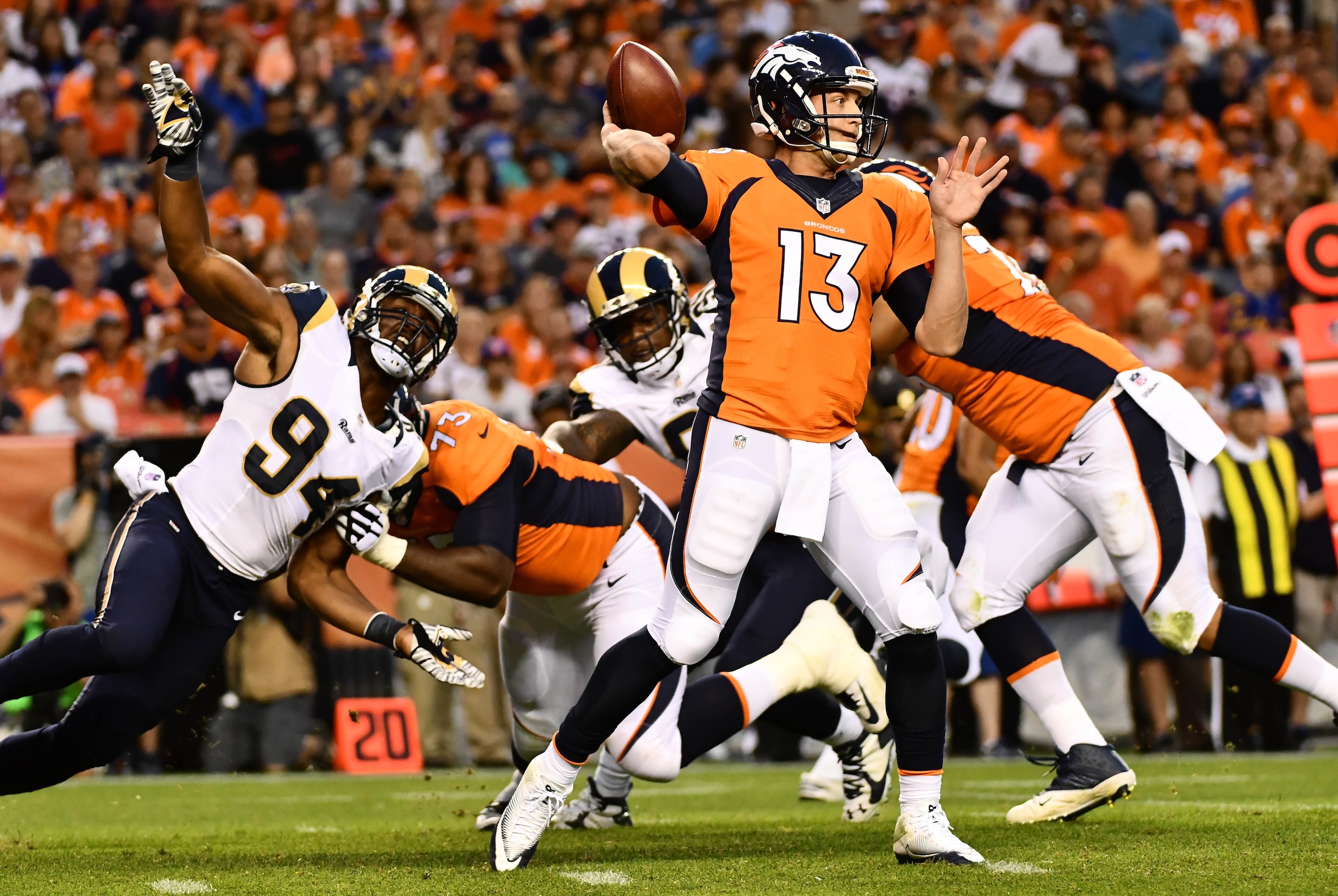 Aug 27, 2016; Denver, CO, USA;  Los Angeles Rams defensive end Robert Quinn (94) pressures Denver Broncos quarterback Trevor Siemian (13) during the first quarter against of a preseason game at Sports Authority Field at Mile High. Mandatory Credit: Ron Chenoy-USA TODAY Sports
