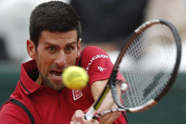 FILE - In this June 3, 2016, file photo, Serbia's Novak Djokovic returns the ball to Austria's Dominic Thiem during their semifinal match of the French Open tennis tournament at the Roland Garros stadium, in Paris. The U.S. Open tennis tournament begins Monday, Aug. 29. (AP Photo/Michel Euler, File)