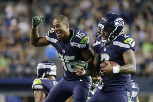 Seattle Seahawks quarterback Trevone Boykin, right, celebrates with wide receiver Tyler Lockett after Boykin scored a touchdown against the Dallas Cowboys during the second half of a preseason NFL football game, Thursday, Aug. 25, 2016, in Seattle. (AP Photo/Elaine Thompson)