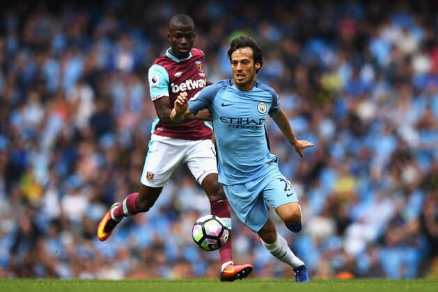 MANCHESTER, ENGLAND - AUGUST 28:  David Silva of Manchester City goes past Enner Valencia of West Ham United during the Premier League match between Manchester City and West Ham United at Etihad Stadium on August 28, 2016 in Manchester, England.  (Photo by Gareth Copley/Getty Images)