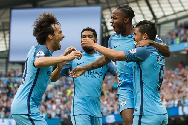Manchester City's English midfielder Raheem Sterling (2nd R) celebrates with Manchester City's Spanish midfielder David Silva (L), Manchester City's French defender Gael Clichy and Manchester City's Spanish midfielder Nolito (R) after scoring their opening goal during the English Premier League football match between Manchester City and West Ham United at the Etihad Stadium in Manchester, north west England, on August 28, 2016. / AFP / JON SUPER / RESTRICTED TO EDITORIAL USE. No use with unauthorized audio, video, data, fixture lists, club/league logos or 'live' services. Online in-match use limited to 75 images, no video emulation. No use in betting, games or single club/league/player publications.  /         (Photo credit should read JON SUPER/AFP/Getty Images)