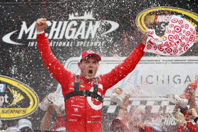 Kyle Larson celebrates after  winning the NASCAR Sprint Cup Series auto race at Michigan International Speedway in Brooklyn, Mich., Sunday, Aug. 28, 2016. (AP Photo/Paul Sancya)