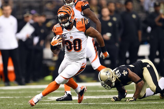 NEW ORLEANS, LA - NOVEMBER 16:  Cedric Peerman #30 of the Cincinnati Bengals avoids a tackle by Corey White #24 of the New Orleans Saints during a game at the Mercedes-Benz Superdome on November 16, 2014 in New Orleans, Louisiana.  Cincinnati defeated New Orleans 27-10.  (Photo by Stacy Revere/Getty Images)
