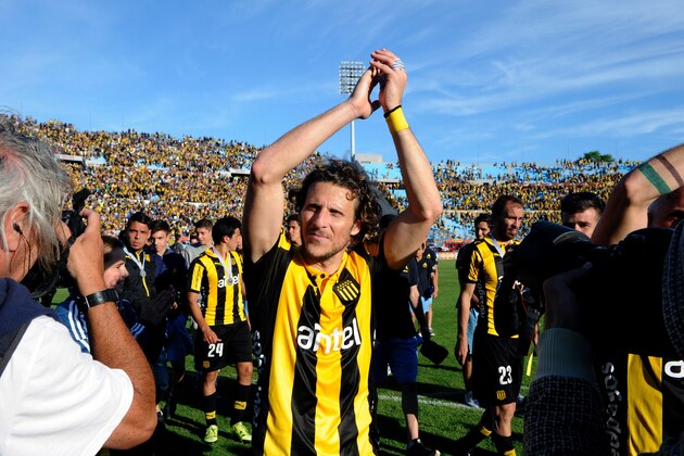 Uruguayan footballer Diego Forlan acknowledges the public after Penarol defeated Juventud 1-0 to win the Apertura football tournament, at the Centenario stadium in Montevideo, on December 6, 2015.  AFP PHOTO / MIGUEL ROJO / AFP / MIGUEL ROJO        (Photo credit should read MIGUEL ROJO/AFP/Getty Images)