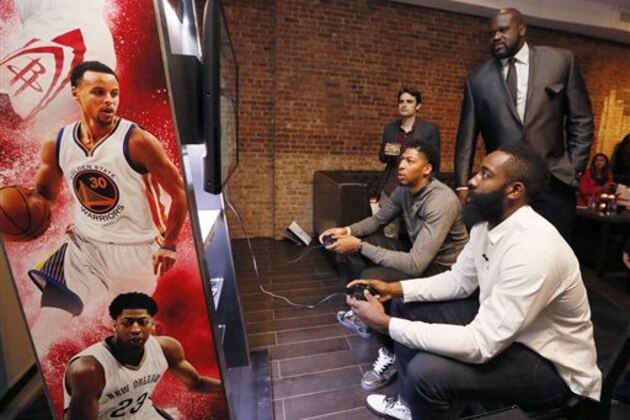 IMAGE DISTRIBUTED FOR 2K - Shaquille O'Neal, right, looks on as Anthony Davis, left, and James Harden, foreground, try their hands at the game during the NBA 2K16 Uncensored Premiere Event at Marquee on Monday, Sept. 21, 2015, in New York. (Photo by Stuart Ramson/Invision for 2K/AP Images)