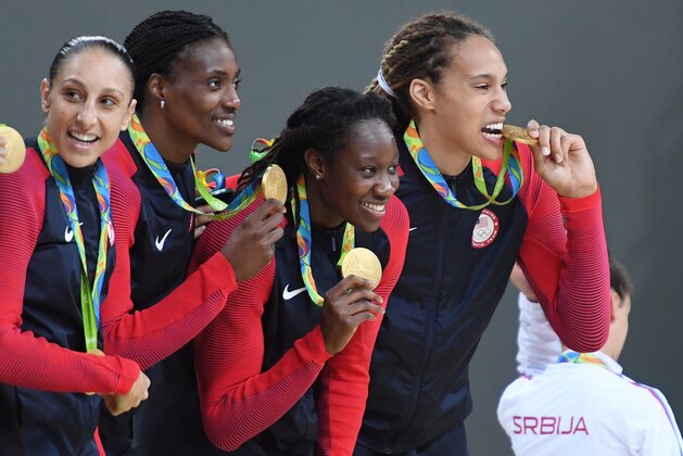 RIO DE JANEIRO, BRAZIL - AUGUST 20:  Diana Taurasi #12, Sylvia Fowles #13, Tina Charles #14 and Brittany Griner #15 of USA Basketball Women's National Team celebrate after winning the Gold Medal Game against Spain on Day 15 of the Rio 2016 Olympic Games at Carioca Arena 1 on August 20, 2016 in Rio de Janeiro, Brazil. NOTE TO USER: User expressly acknowledges and agrees that, by downloading and/or using this Photograph, user is consenting to the terms and conditions of the Getty Images License Agreement. Mandatory Copyright Notice: Copyright 2016 NBAE (Photo by Jesse D. Garrabrant/NBAE via Getty Images)