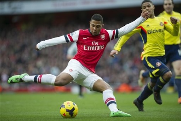 Arsenal's Serge Gnabry  tries to score past Sunderland's Liam Bridcutt during their English Premier League soccer match, at Emirates Stadium, in London, Saturday, Feb. 22, 2014. (AP Photo/Bogdan Maran)