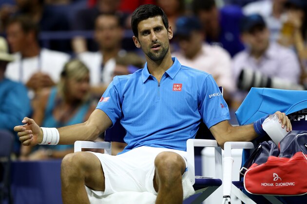 NEW YORK, NY - AUGUST 29:  Novak Djokovic of Serbia & Montenegro rests between games against Jerzy Janowicz of Poland during his first round Men's Singles match on Day One of the 2016 US Open at the USTA Billie Jean King National Tennis Center on August 29, 2016 in the Flushing neighborhood of the Queens borough of New York City.  (Photo by Elsa/Getty Images)