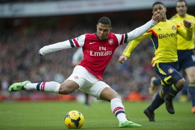 Arsenal's Serge Gnabry  tries to score past Sunderland's Liam Bridcutt during their English Premier League soccer match, at Emirates Stadium, in London, Saturday, Feb. 22, 2014. (AP Photo/Bogdan Maran)
