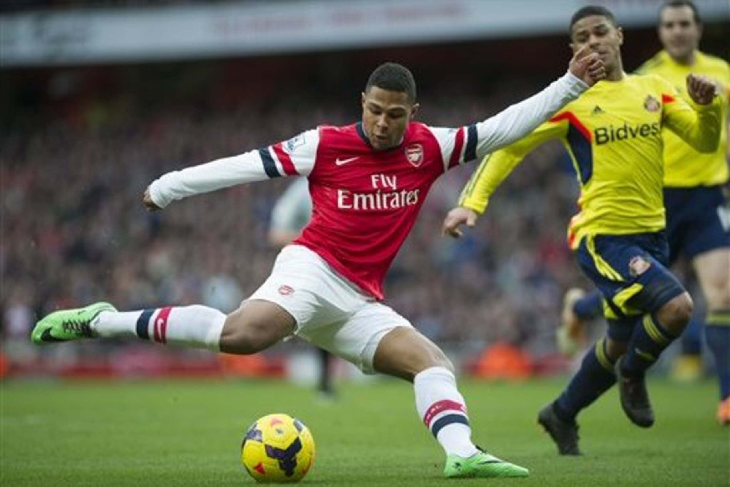 Arsenal's Serge Gnabry  tries to score past Sunderland's Liam Bridcutt during their English Premier League soccer match, at Emirates Stadium, in London, Saturday, Feb. 22, 2014. (AP Photo/Bogdan Maran)