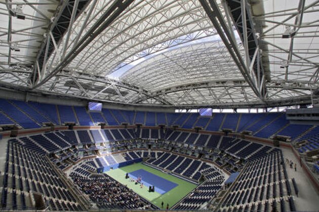 FILE - In this Aug. 2, 2016, file photo, the partially open new retractable roof allows a ribbon of light into Arthur Ashe Stadium at the Billie Jean King National Tennis Center, in the Queens borough of New York. The first round of the U.S. Open tennis tournament is scheduled for Monday, Aug. 29. (AP Photo/Richard Drew, File)