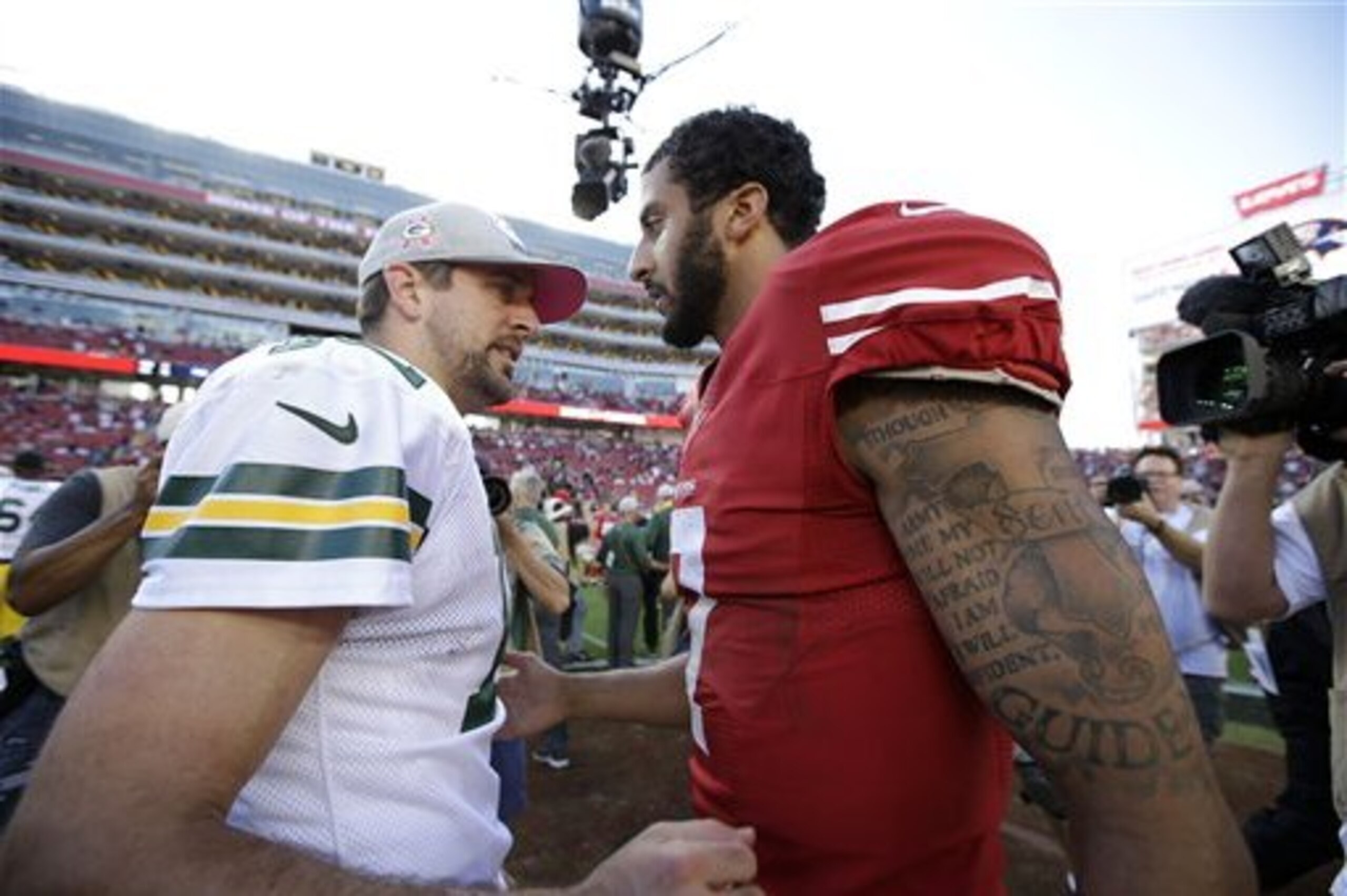 Green Bay Packers quarterback Aaron Rodgers, left, greets San Francisco 49ers quarterback Colin Kaepernick after an NFL football game in Santa Clara, Calif., Sunday, Oct. 4, 2015. (AP Photo/Marcio Jose Sanchez)