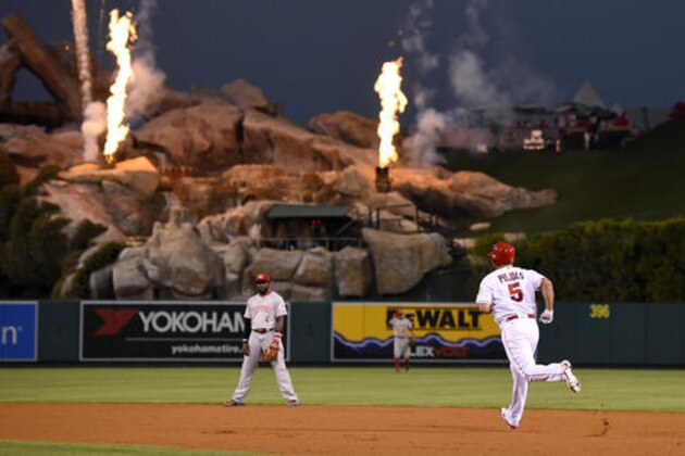 Los Angeles Angels' Albert Pujols, right, runs the bases after hitting a solo home run as Cincinnati Reds second baseman Brandon Phillips watches during the first inning of a baseball game, Monday, Aug. 29, 2016, in Anaheim, Calif. (AP Photo/Mark J. Terrill)