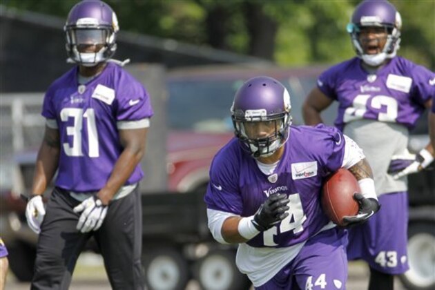 Minnesota Vikings running back Matt Asiata (44) carries the ball in front of running backs Jerick McKinnon (31) and Dominique Williams (43) during an NFL organized training activity in Eden Prairie, Minn., Wednesday, June 11, 2014. (AP Photo/Ann Heisenfelt)