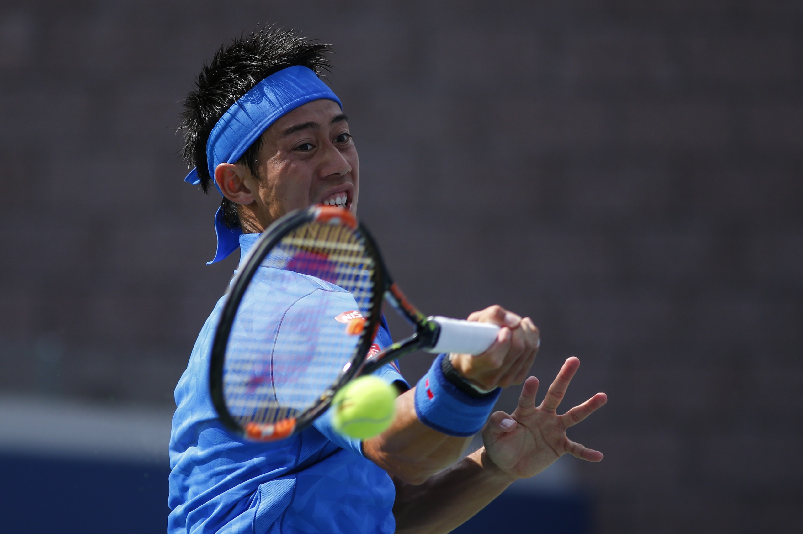 Kei Nishikori of Japan hits a return to Benjamin Becker of Germany during their 2016 US Open Men's Singles match at the USTA Billie Jean King National Tennis Center in New York on August 30, 2016 / AFP / KENA BETANCUR        (Photo credit should read KENA BETANCUR/AFP/Getty Images)
