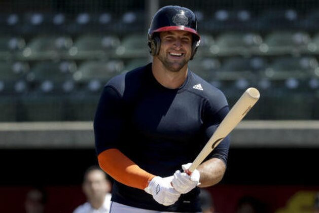 Former NFL quarterback, Tim Tebow smiles during a work out for baseball scouts and the media during a showcase on the campus of the University of Southern California, Tuesday, Aug. 30, 2016 in Los Angeles. The Heisman Trophy winner works out for a big gathering of scouts on USC's campus in an attempt to start a career in a sport he hasn't played regularly since high school. (AP Photo/Chris Carlson)