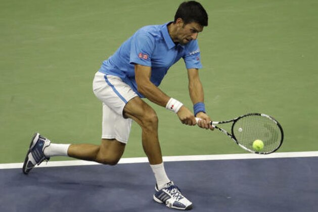 Novak Djokovic, of Serbia, returns a shot to Jerzy Janowicz, of Poland, during the first round of the US Open tennis tournament, Monday, Aug. 29, 2016, in New York. (AP Photo/Julio Cortez)