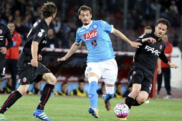 Napoli forward Manolo Gabbiadini, center, is challenged by Bologna's Matteo Brighi, right, during a Serie A soccer match at the Naples San Paolo stadium, Italy, Tuesday, April 19, 2016. (Ciro Fusco/ANSA via AP)