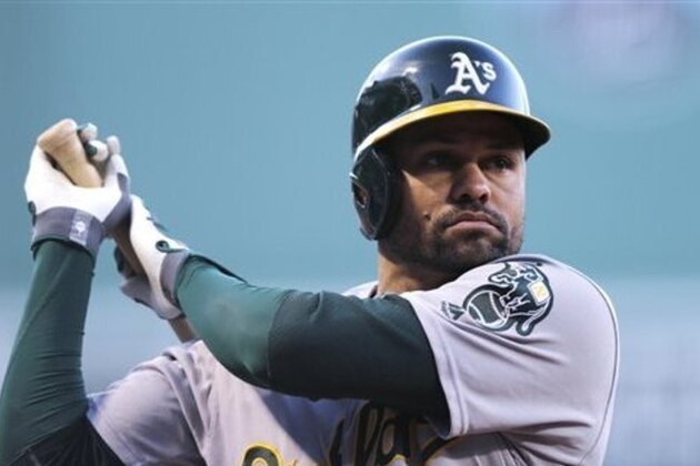 Oakland Athletics' Coco Crisp warms up before the first inning of a baseball game at Fenway Park in Boston, Monday, May 9, 2016. (AP Photo/Charles Krupa)